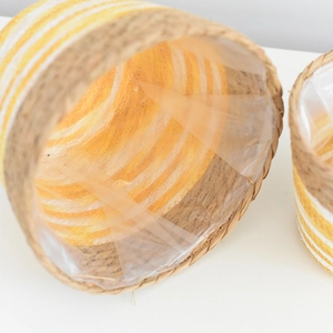 Detail of hand-woven flower basket with yellow stripes and waterproof plastic liner