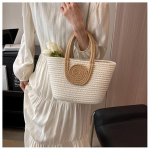Detail of woven tote bag featuring brown spiral pattern and comfortable cotton handles