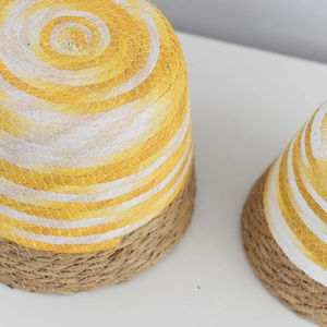Close-up of yellow and white woven paper rope texture on a conical planter basket