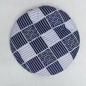 Detail of round woven cat bed cushion with blue and white Japanese geometric wave patterns