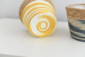 Close-up of handwoven wicker flower pots with waterproof liners and colorful patterns