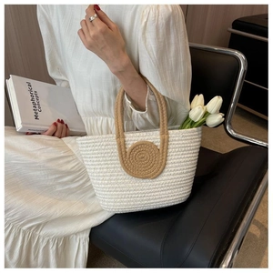 Detail of hand-woven tote bag in cream and brown with spiral pattern and cotton texture