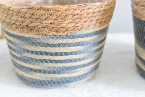 Macro shot of handwoven grass basket featuring blue and white striped textured details