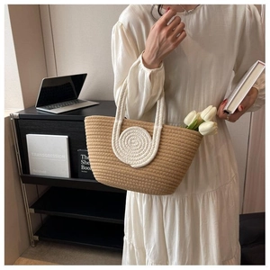 Close-up of handmade woven tote bag with ivory cord circle design and soft rope handle