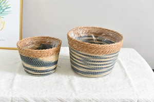 Detail of woven straw plant baskets with waterproof liners and blue striped pattern