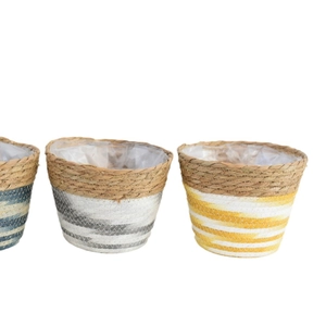 Three conical woven seagrass planter baskets in blue grey and yellow with waterproof liners