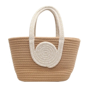 Handwoven straw tote bag in brown and beige featuring a circular spiral pattern and sturdy handle