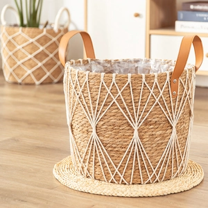 Handwoven seagrass basket with white cotton lattice net and brown leather handles
