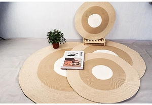 Macro view of woven cotton rope coasters in tiered sizes with natural beige and brown tones