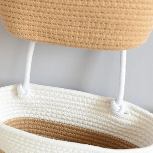 Detail of hand-woven cotton and jute wall hanging basket with double-tier texture