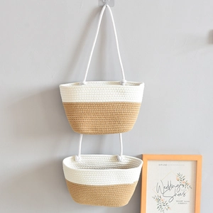 Detail of handwoven double-tier wall hanging basket in beige and khaki cotton rope