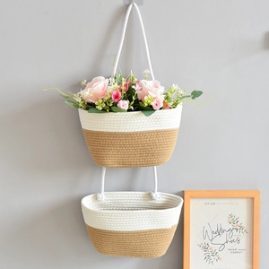 Detail of double-layer woven cotton rope hanging basket with artificial floral decoration