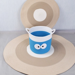 Blue and white woven cotton rope basket with eye decoration for home storage