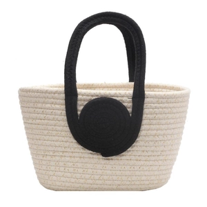 Handwoven beige cotton tote bag with metallic accents and contrast black round handles