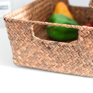 Detailed close-up showing handcrafted weave pattern and hollow handle of the storage basket