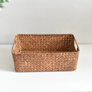Detail of handwoven brown storage basket showing natural fiber texture and metal frame