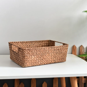 Detailed close-up showing the dense hand-woven natural seagrass texture and built-in handle