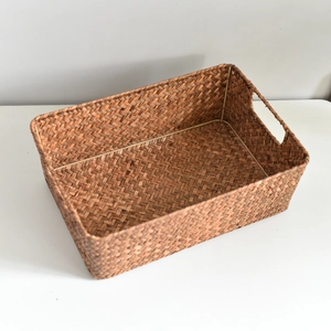 Detail showing the internal metal frame and natural seagrass weaving of the storage basket