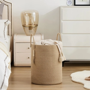 Woven cotton rope storage basket with decorative tassels and wood beads for home laundry