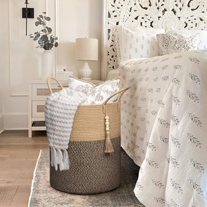 Detail of hand-woven cotton rope basket with dual-tone design and elegant tassel charm