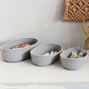 Three-piece set of oval grey woven cotton rope storage baskets for home organization