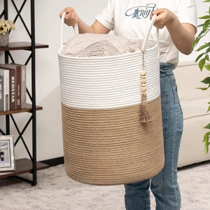 Detail of large woven cotton rope storage basket with stylish wood bead tassel accents