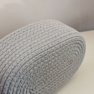 Detailed macro view of gray oval cotton rope storage basket showing braided texture