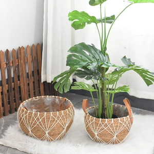 Nordic hand-woven seagrass planters with geometric cotton patterns and leather handles