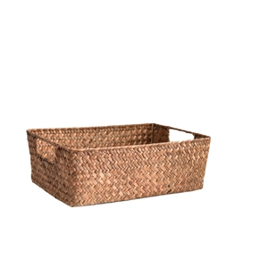 Handwoven rectangular seagrass storage basket with cutout handles on a white background