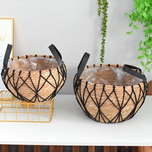 Close-up of handwoven wicker planter basket set with waterproof lining and black net detail