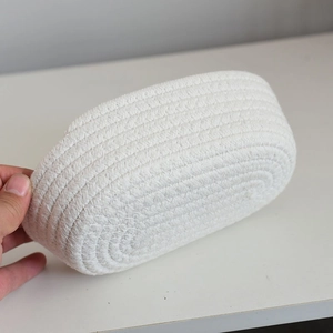 Close-up showing the hand-woven cotton rope texture and spiral pattern of the storage basket