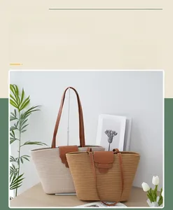 Close-up of woven cotton tote bags in beige and brown with leather straps and snap closure
