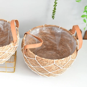 Close-up of Nordic woven straw planter with white mesh, leather handles and plastic lining
