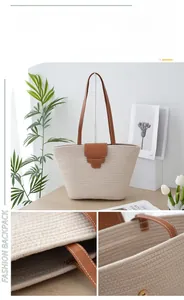 Detail view of woven beach bag showing magnetic buckle closure and internal pocket