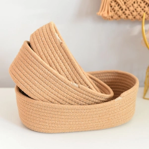 Three-piece oval hand-woven cotton rope storage basket set in natural brown finish