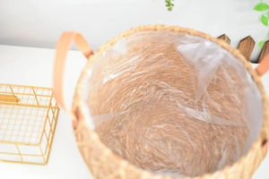 Detailed view of hand-woven seagrass planter basket with waterproof liner and leather handles