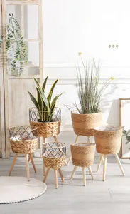 Detail of Nordic woven plant baskets with solid wood tripod stands for home decor