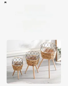 Detailed view of woven plant stand set with natural wooden legs and plastic liner