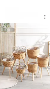 Detail of Nordic woven rattan plant stand with solid wood legs and waterproof lining