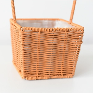Detail view of woven flower basket featuring waterproof lining and sturdy dual handles