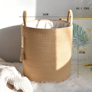 Detailed macro view of a cotton rope laundry basket with white lining and tassel charm