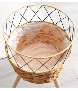 Detail of woven straw plant pot with black metal frame and waterproof liner