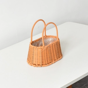 Close-up of orange-brown woven flower basket with double handles and waterproof plastic liner