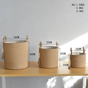 Detailed view of woven cotton rope baskets with tassels and wooden beads in three sizes
