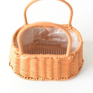 Detail of hand-woven orange plastic flower basket with waterproof inner lining