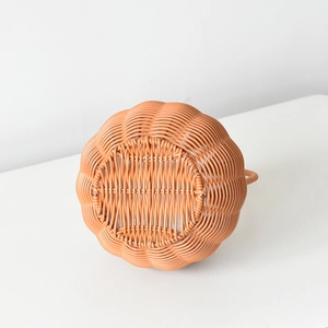 Detailed close-up of the intricate pumpkin-shaped woven basket with reinforced bottom