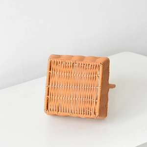 Close-up of the intricate weave pattern on the bottom of a woven flower basket