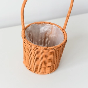 Detail of woven flower basket with waterproof plastic lining and dual handles