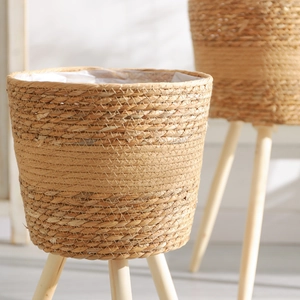 Nordic hand-woven rattan plant stand with solid wood tripod legs for indoor home decoration