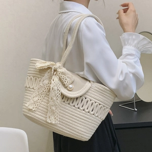 Elegant beige woven tote bag with lace bow and pearl clasp for a romantic French aesthetic